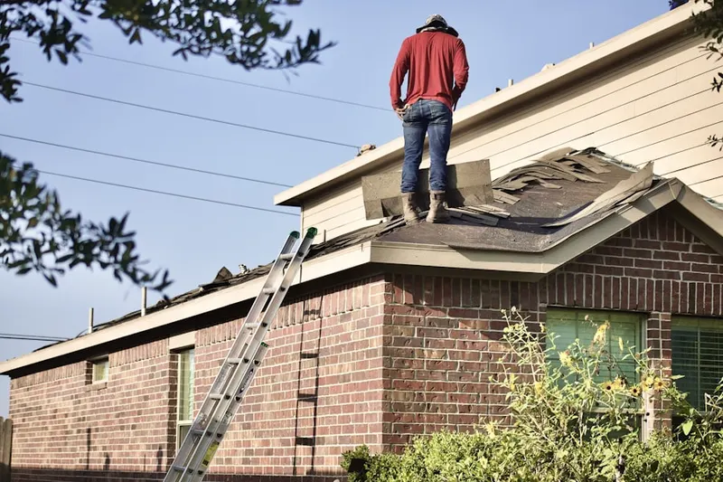 Professional roofer working on a residential roof in Oak Tree